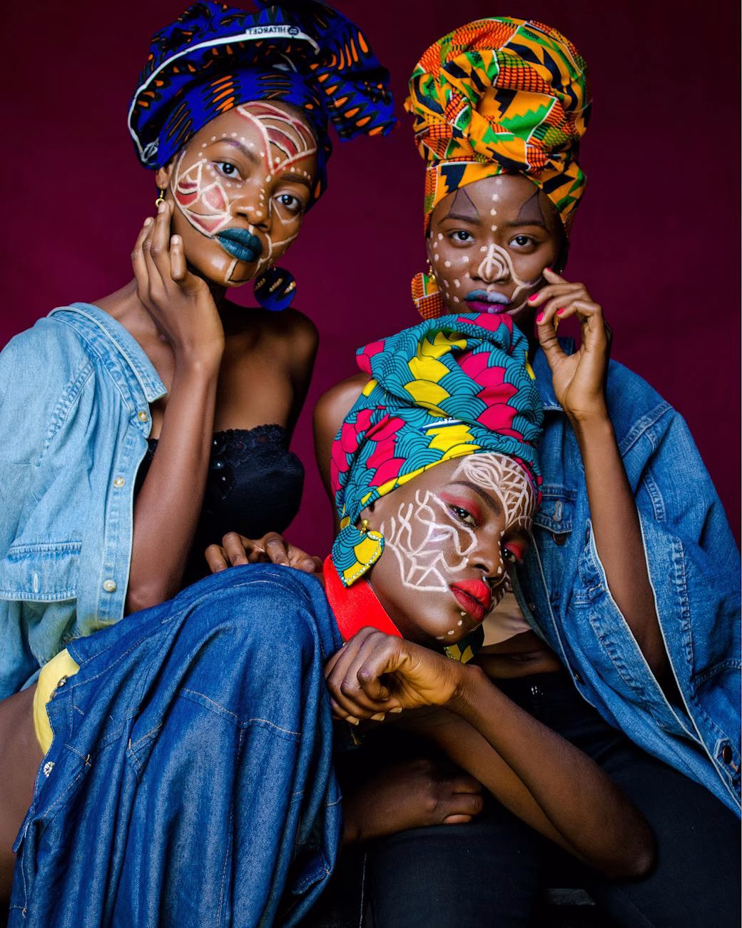 three woman with face paintings